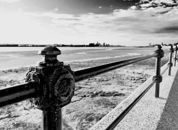 Close-up of railing against river