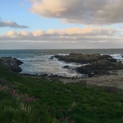 Scenic view of sea against cloudy sky