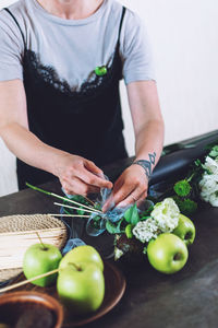 Midsection of woman preparing food at kitchen