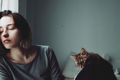 Portrait of woman with cat at home