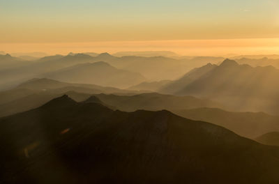 Scenic view of mountain range against sky during sunset