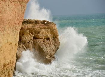 Waves splashing on rock formation