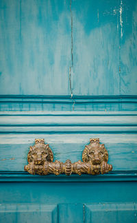 Close-up of old metal door on wall