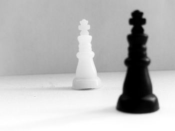 Close-up of chess pieces against white background