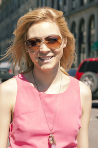 Woman in pink dress walking in city