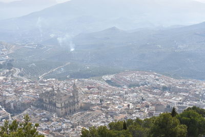 Aerial view of historic building amidst cityscape during sunny day