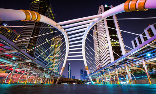 Low angle view of illuminated buildings against sky at night