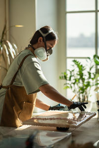 Side view of man working in workshop