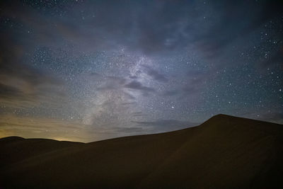 Scenic view of silhouette mountain against sky at night