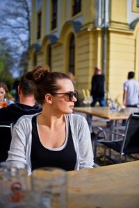Woman in sunglasses sitting at cafe