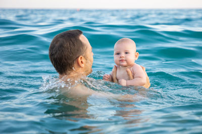 Portrait of shirtless boy swimming in pool