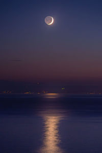 Scenic view of sea against sky at night