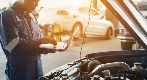 Man standing by car