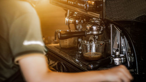 Midsection of woman holding coffee at home