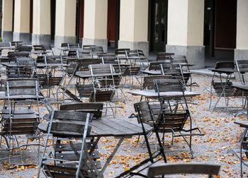 Empty chairs and table in abandoned building