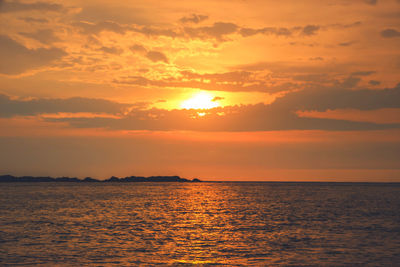 Scenic view of sea against orange sky