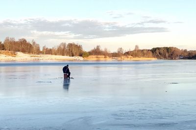 Scenic view of frozen lake against sky during winter