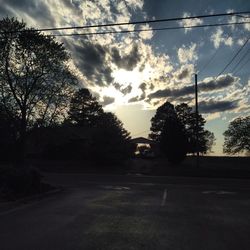 Car on road against cloudy sky