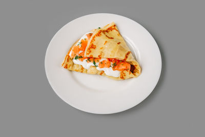 Close-up of food in plate on white background
