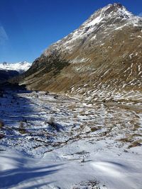 View of snow and mountain peak against clear sky