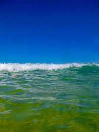 Scenic view of sea against clear blue sky