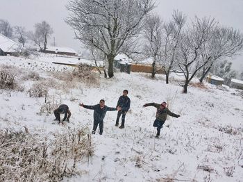 People on snow covered field