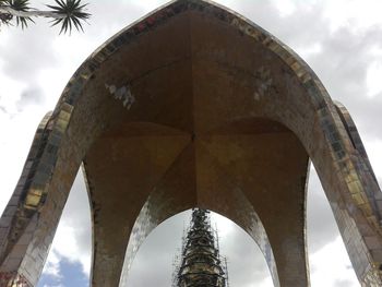 Low angle view of bridge against cloudy sky