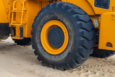 Wheel loader or bulldozer at the beach, ground moving equipment, heavy machinery 