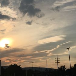 Low angle view of street light against cloudy sky