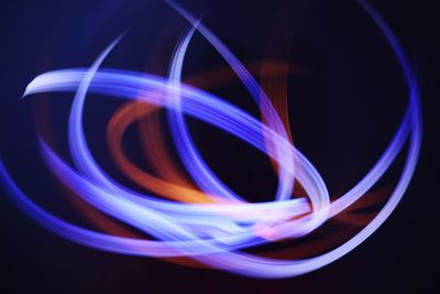 Close-up of light painting against black background