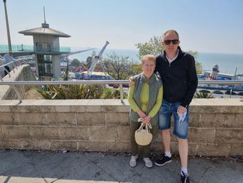 Full length of young woman standing against wall