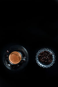 Directly above shot of coffee on table against black background