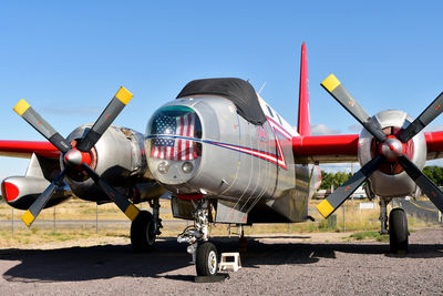 Firefighting plane on airport runway against clear sky