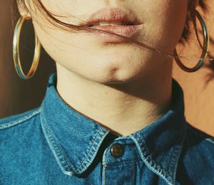 Midsection of woman wearing earrings