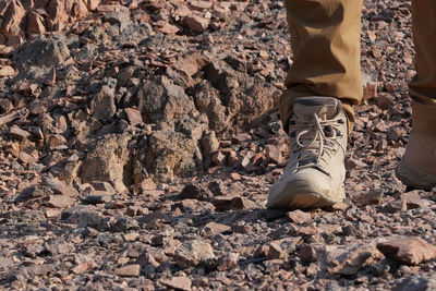 Low section of man standing on rocks