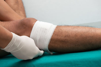 Close-up of healthcare worker giving first aid to patient