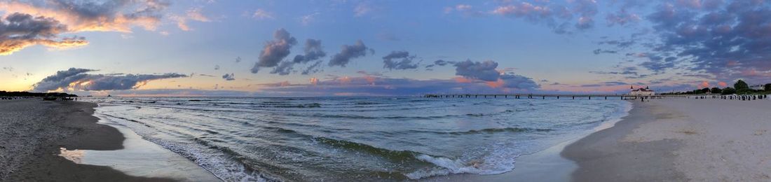 Panoramic view of beach against sky during sunset