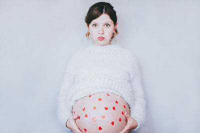 Portrait of woman in snow against white background