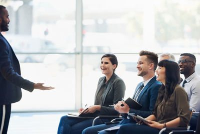 Group of people sitting in front of office