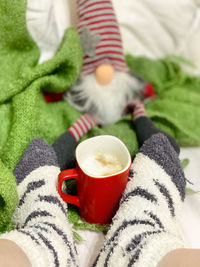 Low section of person holding coffee cup