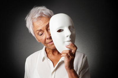 Portrait of man wearing mask against white background