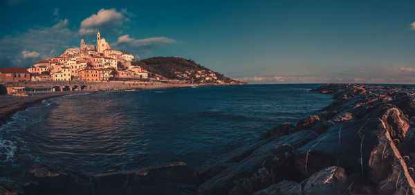 Scenic view of sea and buildings against sky