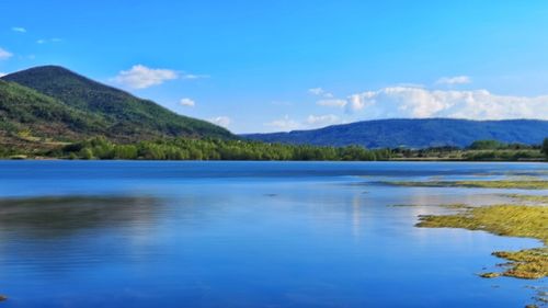 Scenic view of lake against blue sky