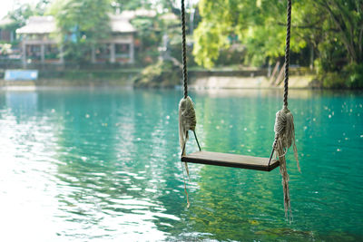 The swing hanging over the beautiful blue lake