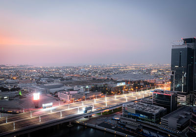 High angle view of illuminated buildings against sky at sunset
