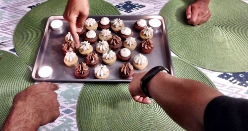 Close-up of man eating food on table