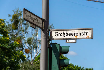 Low angle view of road sign against sky