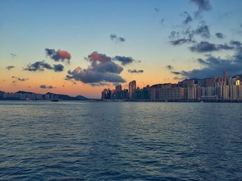 Buildings in city at sunset