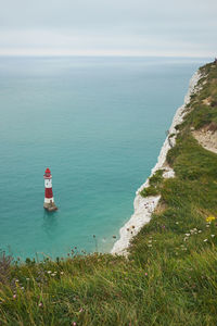 High angle view of beachy head lighthouse and chalk cliff edge.