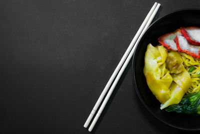 High angle view of salad in plate against black background